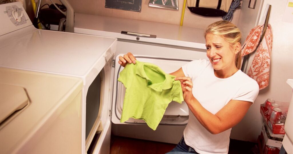 a women hold a shrunken t-shirt